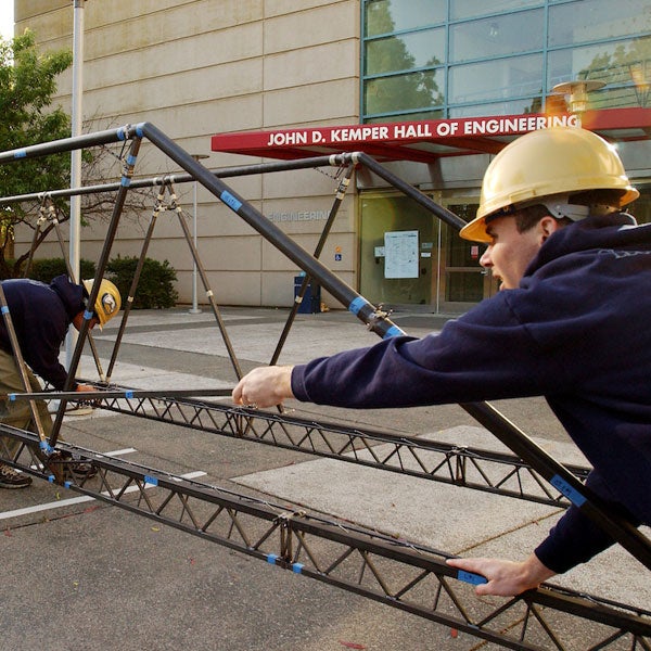 Students build an iron bridge outside of the Engineering complex at TV