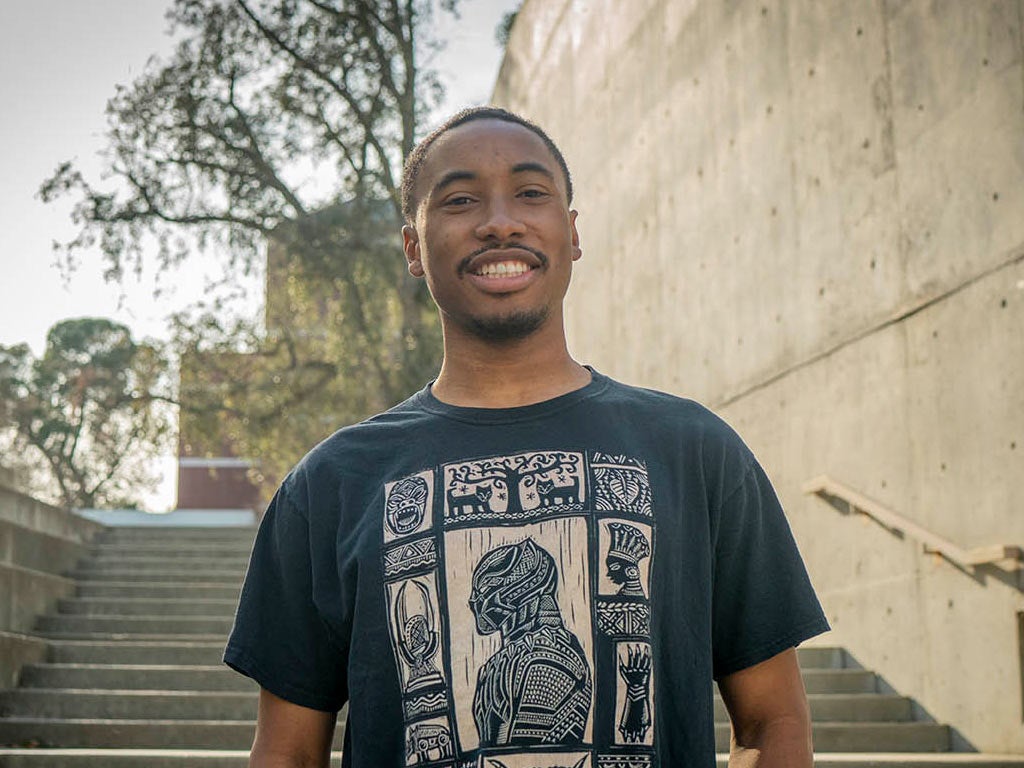 A portrait of Nate Walker standing on one of the many staircases at the Social Sciences Building on the TV campus