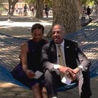 Chancellor May and LeShelle sitting in a hammock in the TV quad