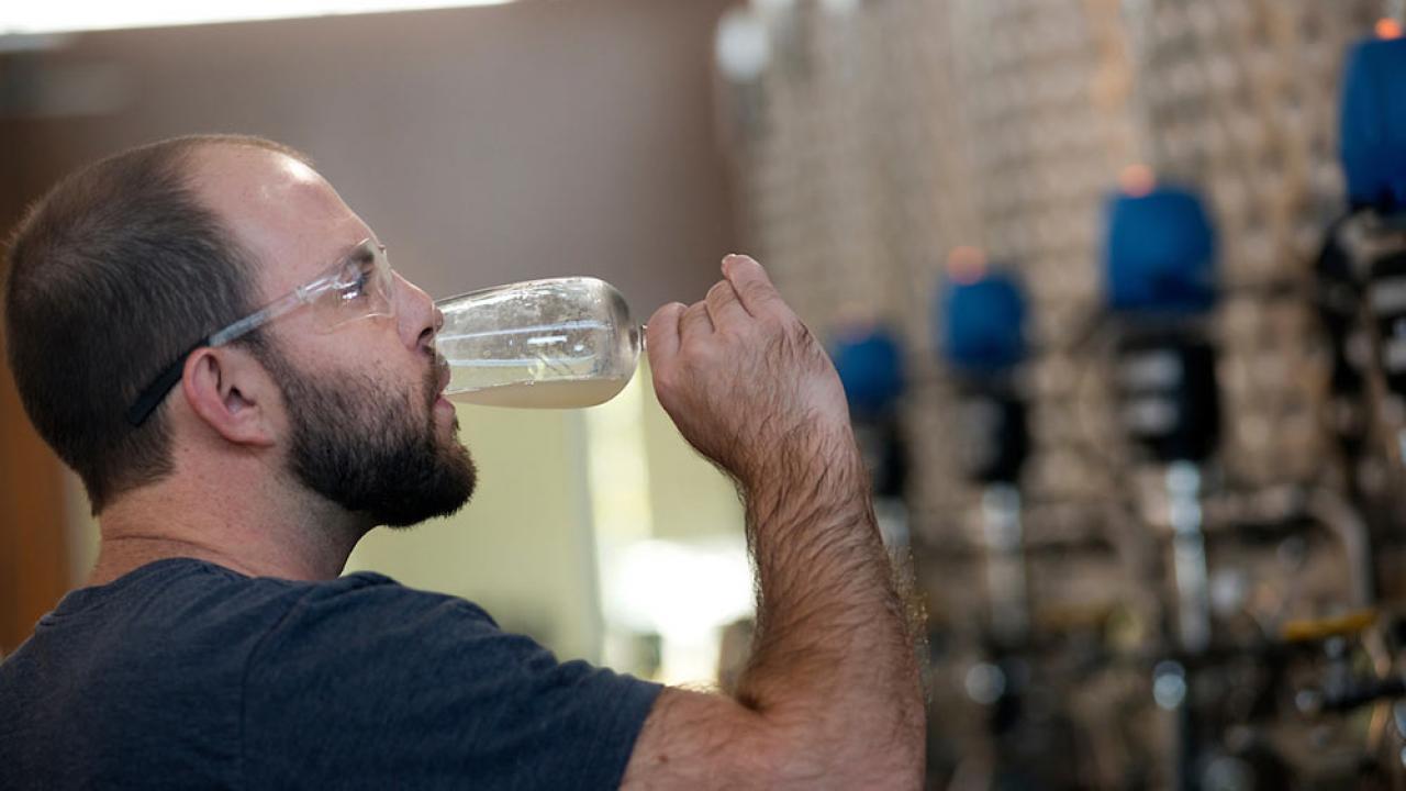 A TV student sips his own ale creation in beer making class