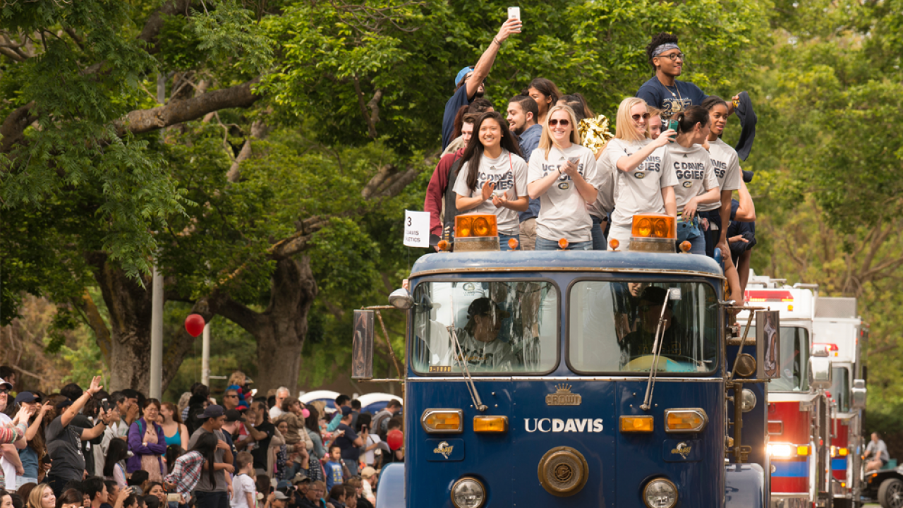 TV students ride on top of a TV branded blue fire engine during the picnic day parade