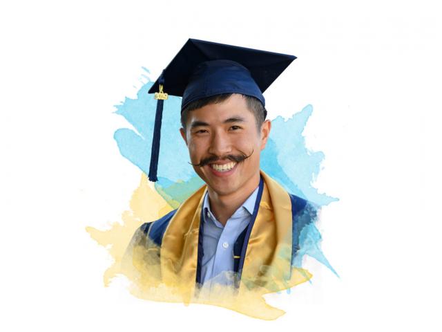 A smiling TV graduate with an amazing mustache