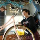A student works on a bicycle at TV. 
