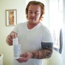 Matthew Treviño holds a canister of a hormonal birth control gel for men while in his home in Sacramento. He is part of a clinical trial at TV Health testing the new drug. 