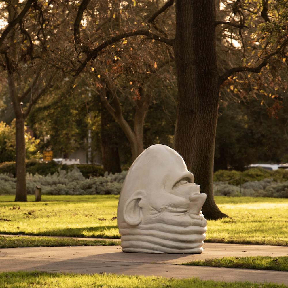 Eye on Mrak egghead sculpture on TV campus at golden hour