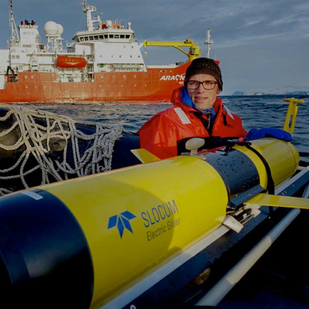 A TV researcher works with a submersible that monitors ocean temperatures