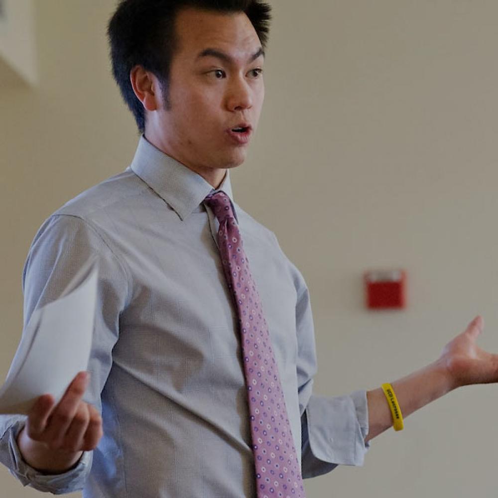 A TV MBA student speaks with his peers